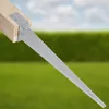 A close-up of a metal ground anchor attached to a wooden post, set against a blurred background of green grass and a blue sky with clouds. Produktbild-Vorschau