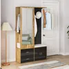 A hallway furniture set with a mirror, storage, and coat rack, placed next to a white door. Produktbild-Vorschau