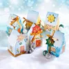 A collection of small, house-shaped advent calendars arranged on a snowy surface with a blurred, bokeh background. Anteprima dell’immagine prodotto
