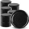 A stack of black jar lids and one lid in the foreground with a decorative pattern. Voir les images du produit