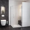 A modern bathroom with a toilet, shower cabin, and dark tiled walls. Produktbild-Vorschau