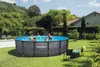 A family enjoys a day in their backyard pool on a sunny day. Produktbild-Vorschau
