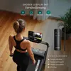 A woman is using a treadmill while watching a tablet, with a remote control and feature descriptions visible. Produktbild-Vorschau