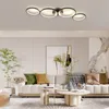 A modern living room with a sofa, coffee tables, and a ceiling light. Voir les images du produit