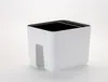 A white planter with a black interior sits on a white surface. Náhled obrázku produktu
