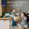 A mother and daughter are doing laundry together in a modern laundry room. Produktbild-Vorschau