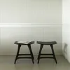 Two black stools in front of a textured wall. Náhľad obrázku produktu