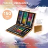 An open wooden art set case filled with drawing and coloring supplies, with a smaller image of the closed case to the side. Náhled obrázku produktu