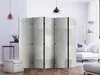 A room divider is set up in a modern living room with furniture and decor. Náhled obrázku produktu