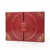 A closed red advent calendar with gold floral patterns and a circular design in the center. Produktbild-Vorschau
