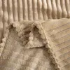 A close-up view of a folded beige blanket with a ribbed texture. Produktbild-Vorschau