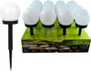 A display of solar garden lights, with one light in the foreground and a box of lights in the background. Produktbild-Vorschau