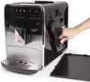 A hand is shown removing a part from the side of a Melitta Caffeo Barista T Smart F831-101 coffee machine. Produktbild-Vorschau