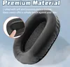 A close-up of a black headphone earpad with a finger pressing on it, highlighting its softness. Podgląd zdjęcia produktu