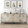 A white marble sideboard with walnut trim and black legs, displayed in a room with framed art on the wall and decorative items on top. Podgląd zdjęcia produktu