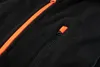 A close-up view of a black fleece sweatshirt with an orange zipper. Podgląd zdjęcia produktu