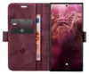 A burgundy flip case for a smartphone, open to reveal card slots and a banknote, with the phone screen displaying the time and date. Produktbild-Vorschau