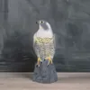 A realistic falcon figurine stands on a gray base against a textured gray background. Náhľad obrázku produktu