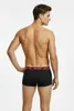 A man wearing black boxer shorts with a burgundy waistband, shown from the back. Produktbild-Vorschau