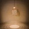 A hanging pendant light made of woven material, casting intricate shadows on a wall and floor. Produktbild-Vorschau