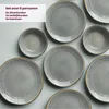 A set of grey ceramic plates and bowls arranged on a light grey surface. Náhled obrázku produktu