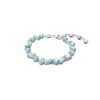A bracelet with blue and clear stones on a white background. Produktbild-Vorschau