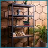 A metal shelving unit filled with books and a bust, set against a hexagonal wooden wall. Podgląd zdjęcia produktu