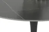 A close-up view of a round dining table with a black marble-look sintered stone top and an anthracite trumpet base. Produktbild-Vorschau