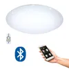 A ceiling light with a remote control, a Bluetooth logo, and a smartphone displaying a lighting app. Produktbild-Vorschau