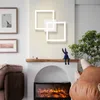 A modern living room with a fireplace, sofa, and wall art. Produktbild-Vorschau