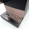A close-up view of the drip tray and lower front panel of a coffee machine. Produktbild-Vorschau