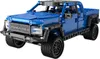 A blue toy truck with black accents and wheels, shown from a three-quarter front angle against a white background. Náhľad obrázku produktu