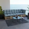 A pallet sofa with blue cushions on a balcony overlooking the ocean. Voir les images du produit