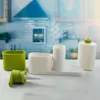 A kitchen sink organizer set with a soap dispenser, a green container, and white organizers on a countertop. Produktbild-Vorschau