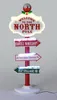 A lighted Christmas decoration signpost with directional arrows pointing to different North Pole locations. Podgląd zdjęcia produktu