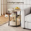 A three-tiered side table with items on each shelf, placed next to a sofa. Produktbild-Vorschau