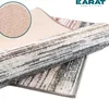 A close-up view of a rolled-up rug with a textured backing visible in a magnified inset. Náhled obrázku produktu