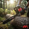 A person is using a chainsaw to cut a log in a forest during sunset. Produktbild-Vorschau