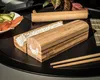 A sushi-making kit with rice, chopsticks, and ingredients on a black tray. Náhľad obrázku produktu