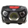 A close-up front view of a black LED headlamp with a red button on top and a fox logo. Náhled obrázku produktu