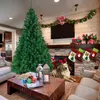 A living room decorated for Christmas with a large artificial Christmas tree, a fireplace with stockings, and a dog wearing reindeer antlers. Podgląd zdjęcia produktu
