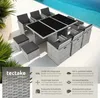 A rattan garden furniture set with a table and chairs arranged around a swimming pool. Produktbild-Vorschau