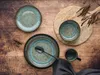 A top-down view of a set of tableware arranged on a wooden surface. Náhľad obrázku produktu