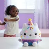 A young girl is dancing in a room with a stuffed toy cat in the foreground. Náhled obrázku produktu