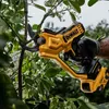 A person's gloved hand is using a yellow and black DeWALT cordless pruner to cut a branch from a leafy plant. Náhled obrázku produktu
