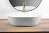 A white vessel sink with a gold faucet is shown on a wooden countertop, with a mirror in the background. Anteprima dell’immagine prodotto