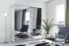 A modern living room with a large mirrored wardrobe, two armchairs, a coffee table, and a floor lamp. Náhled obrázku produktu