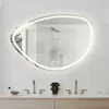 A modern bathroom vanity with two sinks, faucets, and a large oval mirror with integrated LED lighting. Produktbild-Vorschau