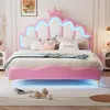 A pink princess-themed bed with LED lighting, decorated with pillows and a crown. Podgląd zdjęcia produktu