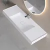 A modern white washbasin mounted on a wall with a faucet and a mirror in the background. Produktbild-Vorschau